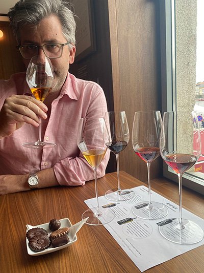 Photo of Adam wine tasting.
