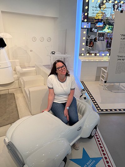 Photo of Merrill in a small toy car.